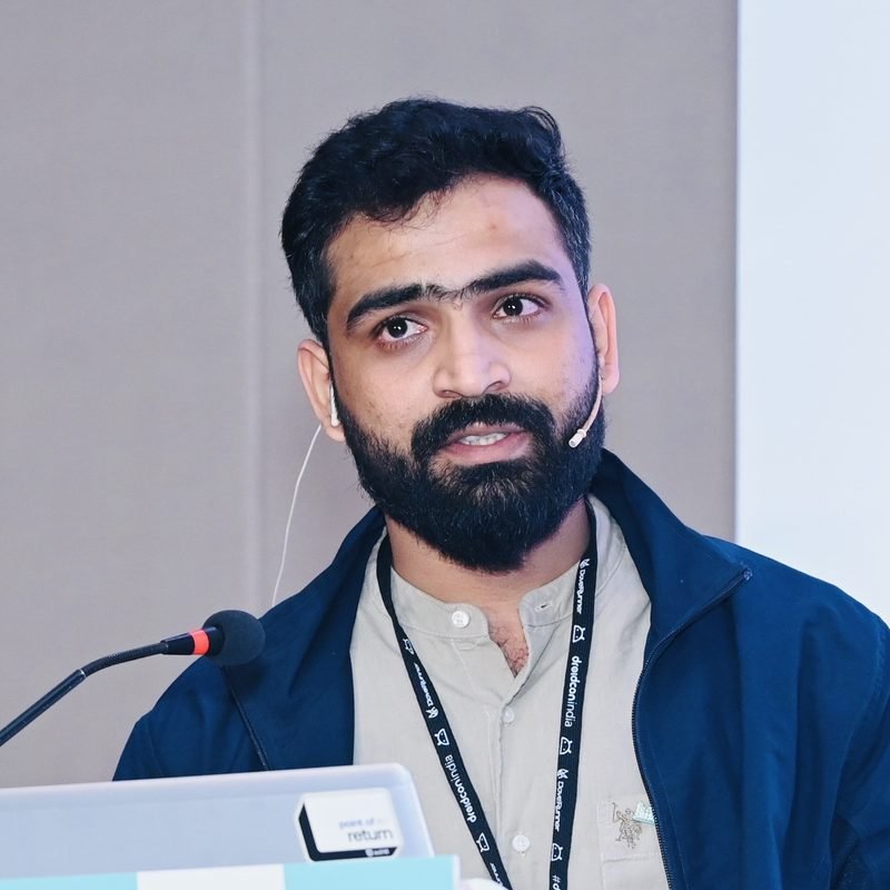 Sidharth B Nair speaking at a podium at droidcon India 2025